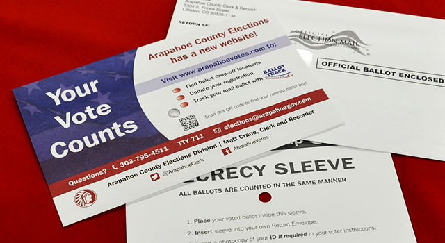 Photo of three envelopes on a red tablecloth