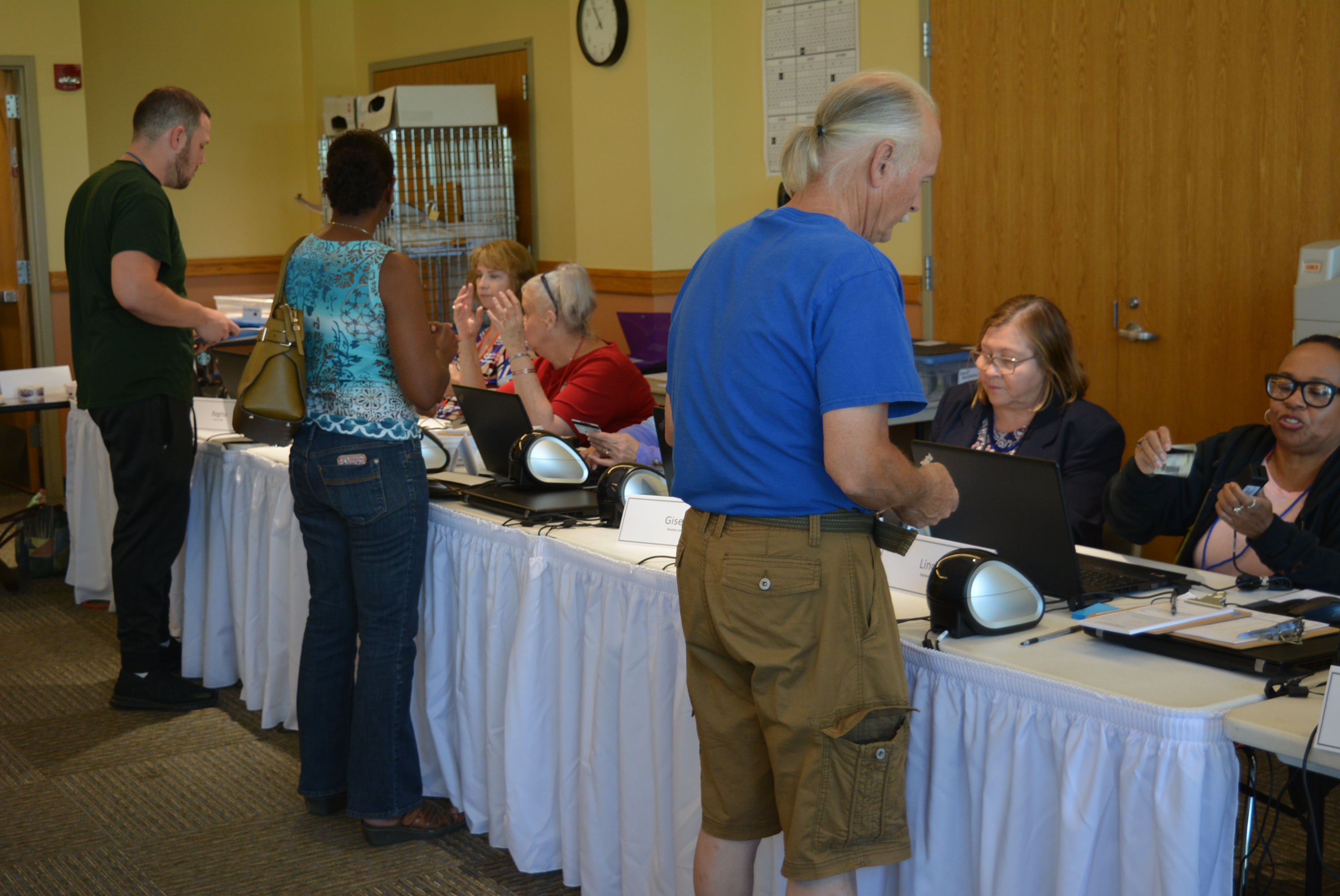 Voters check in at table at Voter Service and Polling Center